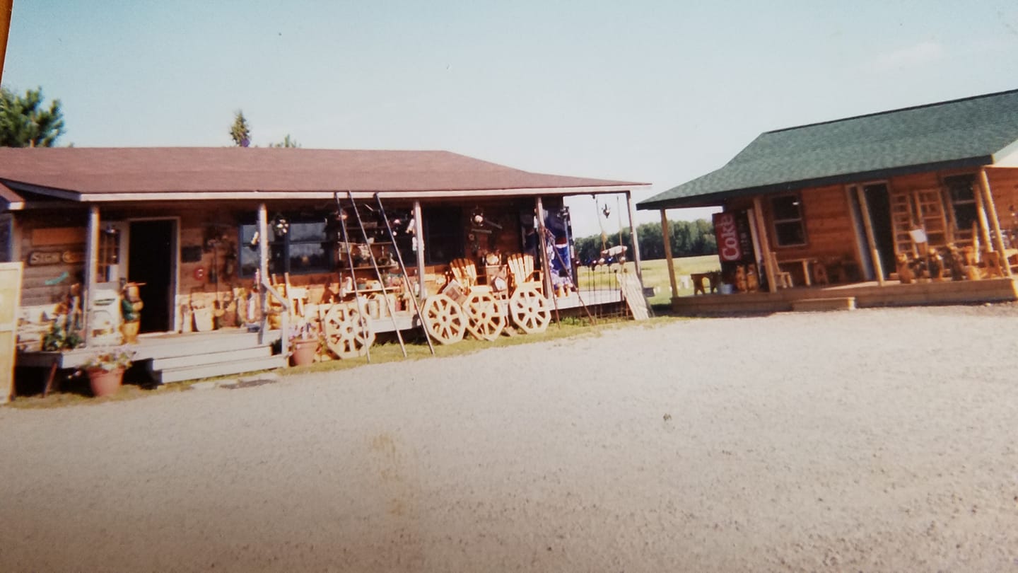 Wooden buildings with a cart in front on a clear day