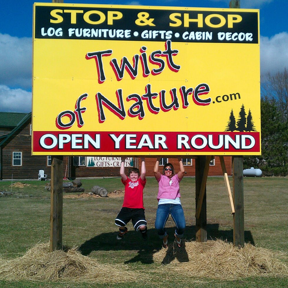 Two people posing in front of a large 'Stop & Shop' sign with 'Twist of Nature' branding.